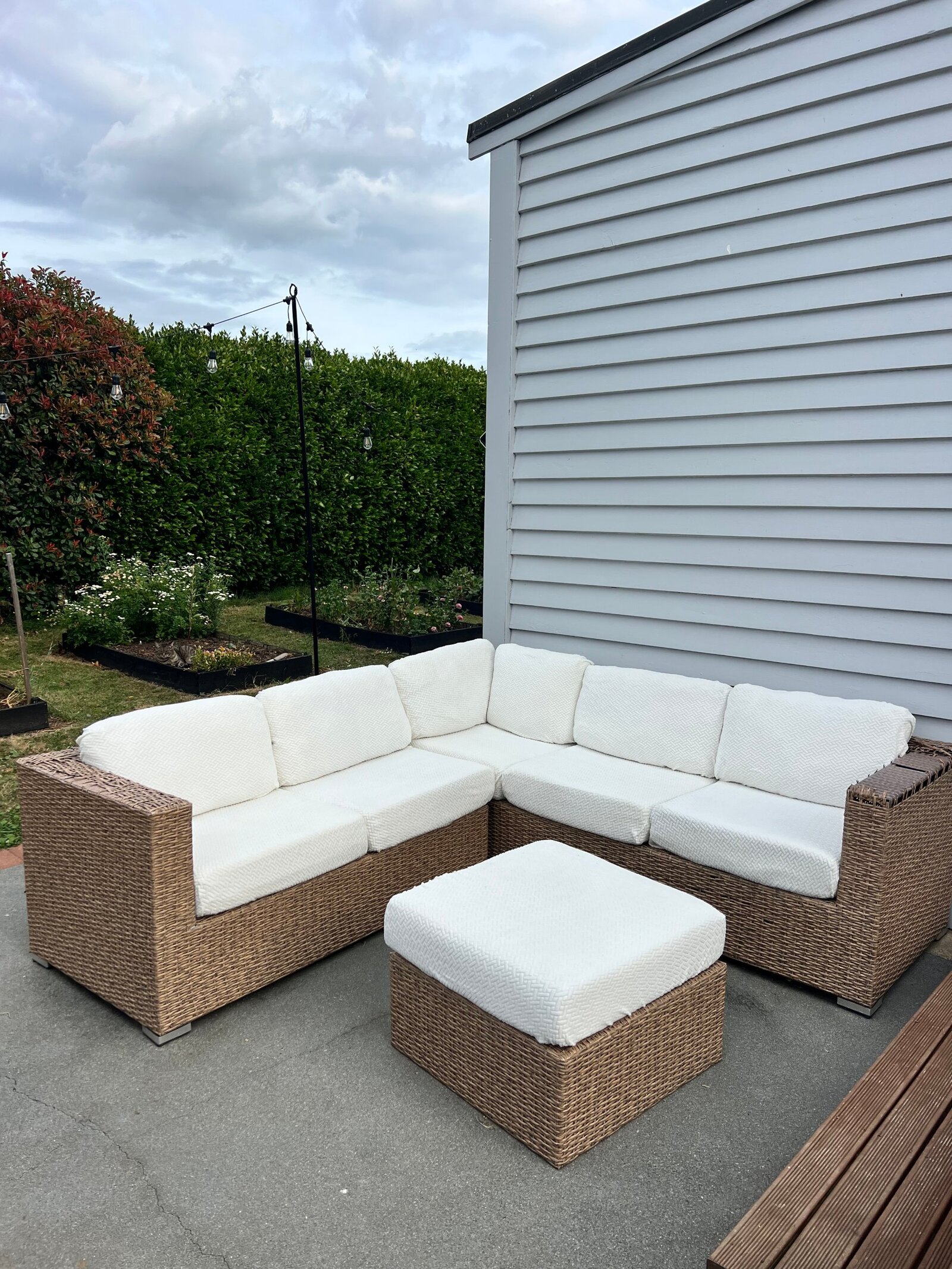 After: the same outdoor sofa with fresh, clean fitted covers
